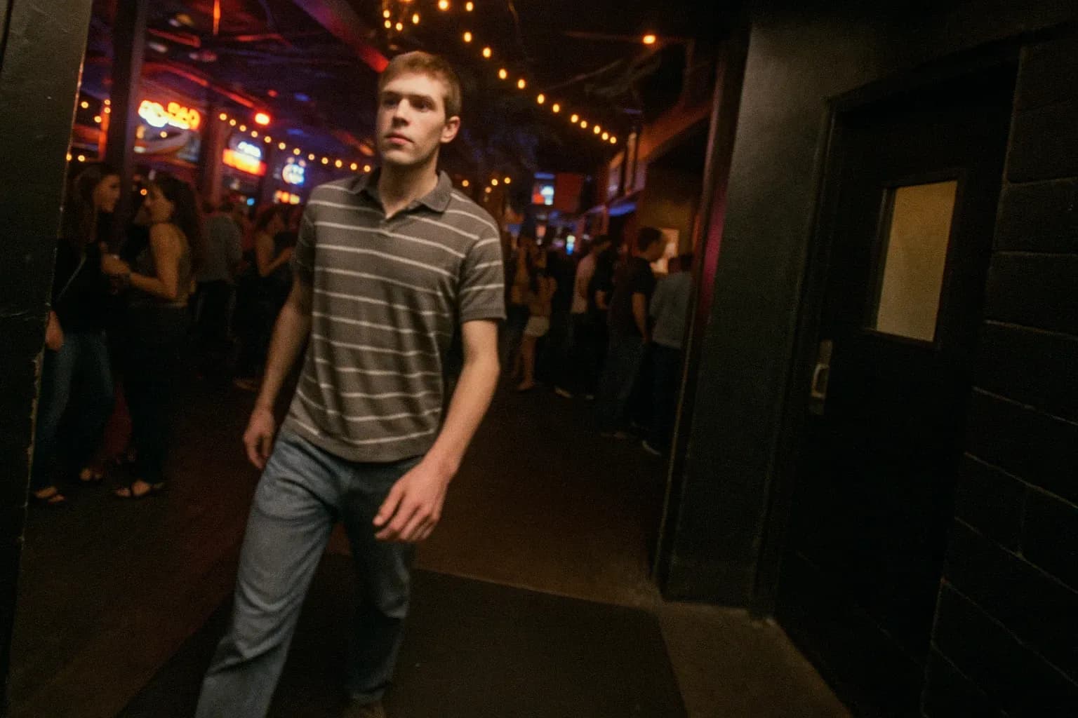 Surveillance footage shows a young man entering the Ugly Tuna Saloona bar in Ohio, surrounded by bustling nightlife, while an exit remains mysteriously void of his presence.
